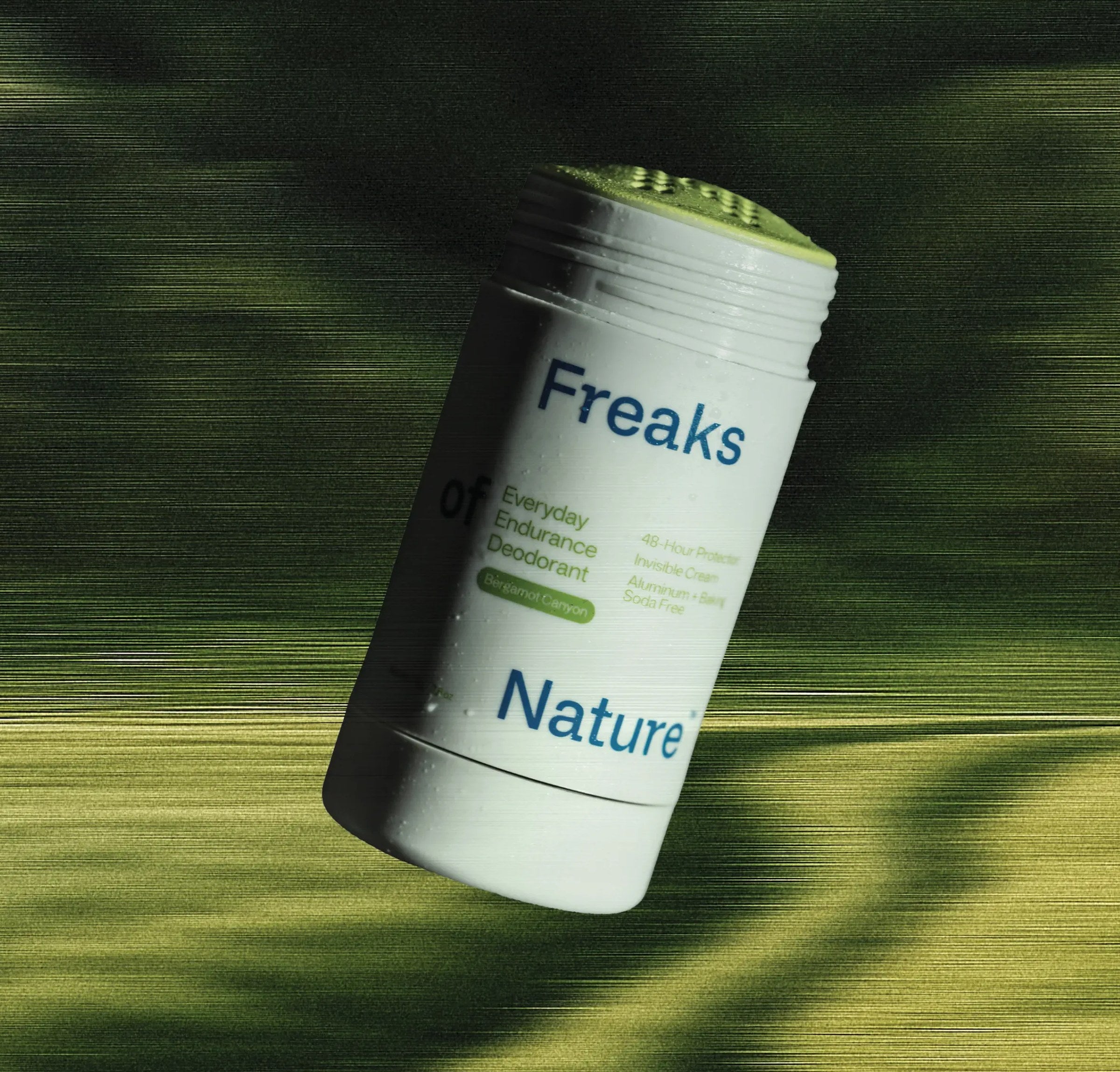 Freaks of Nature Everyday Endurance Deodorant stick over a green field